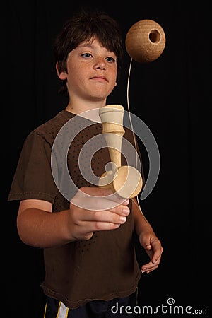 Boy plays with Kendama toy Stock Photo