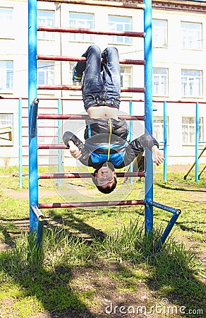 A boy plays outdoors on the playground. Stock Photo