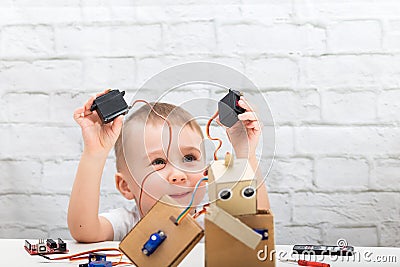 boy plays with the robot and servo Stock Photo