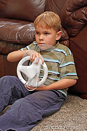 Boy plays video game Stock Photo