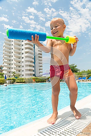A boy plays with a water pistol Stock Photo