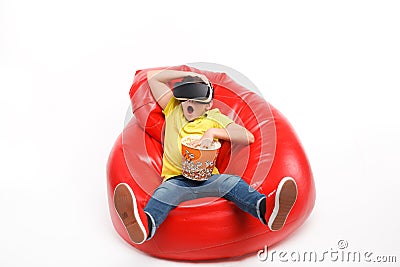 Boy with popcorn in beanbag Stock Photo