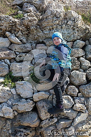 Boy posing on steep bank Stock Photo