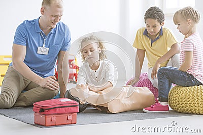 Boy practicing reanimation on manikin Stock Photo