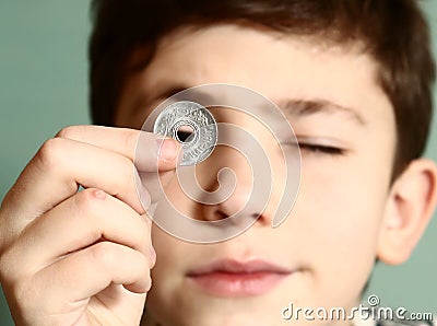 Boy preteen numismatic collector show his coin Stock Photo