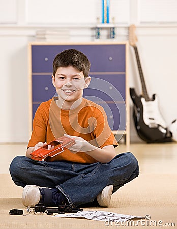 Boy putting together parts of small model car Stock Photo