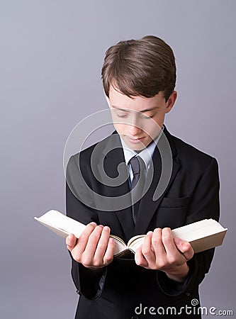 A boy reading the Bible Stock Photo