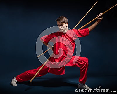 Boy in a red kimono engaged wushu Stock Photo