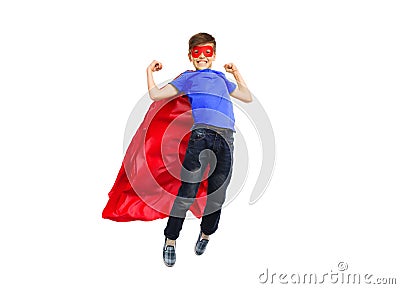 Boy in red super hero cape and mask flying on air Stock Photo