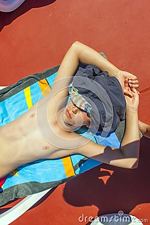 Boy relaxes on a sun lounger Stock Photo