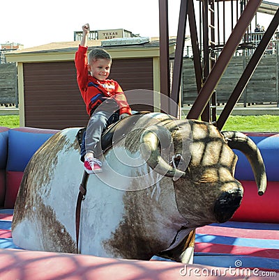A Boy Rides a Mechanical Bull, Fort Worth Stockyards Editorial Stock Photo