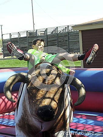 A Boy Rides a Mechanical Bull, Fort Worth Stockyards Editorial Stock Photo