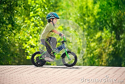 Boy riding bike in a helmet Stock Photo