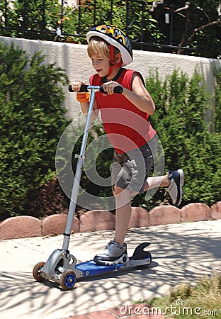 Boy riding scooter Stock Photo