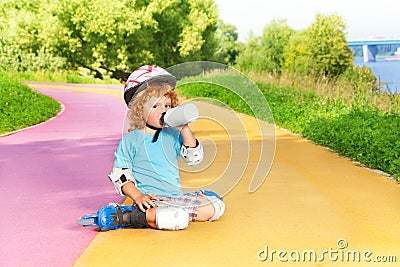 Boy rollerblading and drink water from bottle Stock Photo