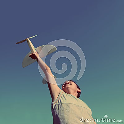 Boy running airplane model - vintage retro style Stock Photo