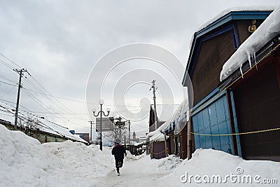 A boy is running in thick snows in Otaru city in Hokkaido Japan 2018 Editorial Stock Photo