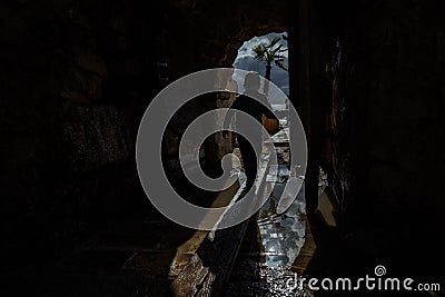 Boy running into tunnel in the dark dungeon Stock Photo