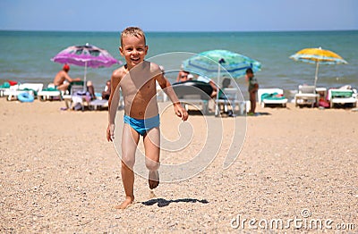 Boy runs on a beach Stock Photo