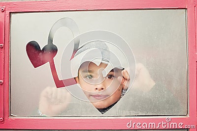 Boy's face in a heart frame Stock Photo