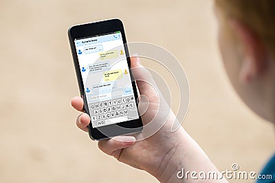 Boy`s Hand Holding Mobile Phone Stock Photo