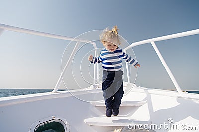 Boy sailor striped shirt sea yacht travel around world. Little sea traveller. Memories made together last lifetime. Baby Stock Photo