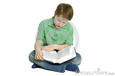 Boy sat reading a book. Stock Photo