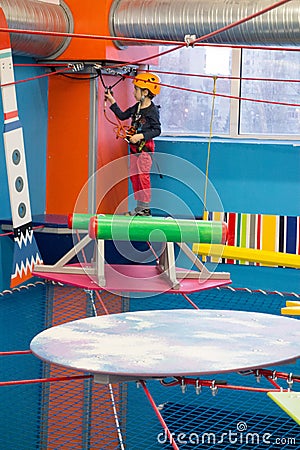 Boy securing the line for adventure park route Stock Photo