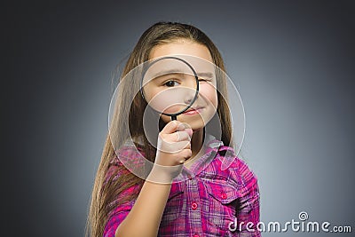 Boy See Through Magnifying Glass, Kid Eye Looking with Magnifier Lens over Gray Stock Photo