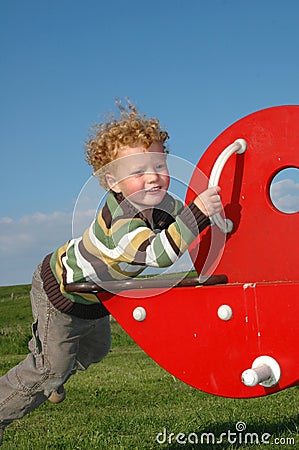 Boy on SeeSaw Stock Photo