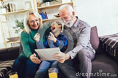 Boy showing his older grandparents new technology Stock Photo