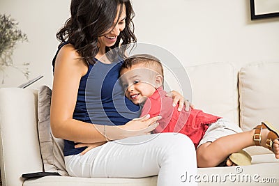 Boy Showing Love Towards Unborn Baby In Mother`s Tummy Stock Photo