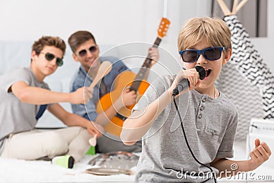 Boy singing to microphone Stock Photo