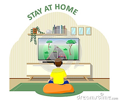 The boy sits in front of the TV, plays video games, the console. Stayed home, quarantine, isolation. Modern Stock Photo