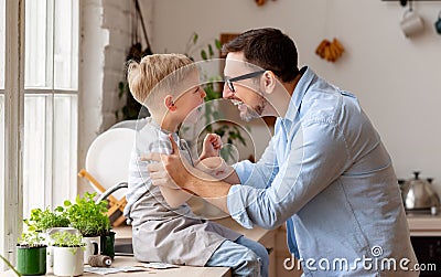 Boy sitting on fathers hands and hugging Stock Photo