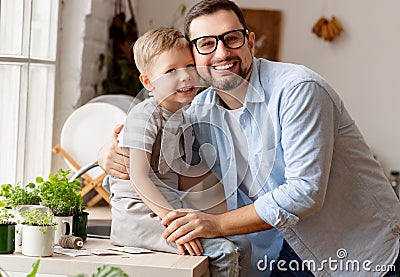 Boy sitting on fathers hands and hugging Stock Photo
