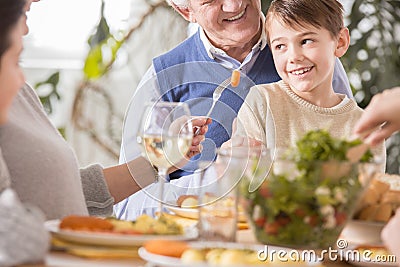 Boy sitting on grandfather`s laps Stock Photo