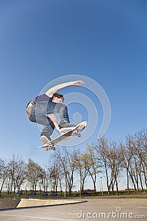 Boy with skate board is going airborne Stock Photo