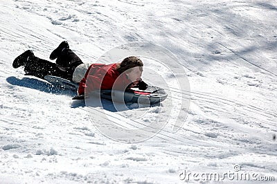 Boy sledding Stock Photo