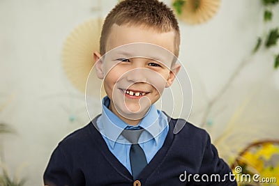 The boy smiles with crooked teeth. Stock Photo