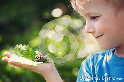 Boy and snail Stock Photo