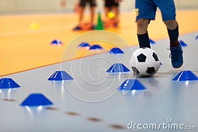 Boy in Soccer Clothes with Futsal Ball on Dribbling Drill. Kid on Indoor Soccer Training With Coach Stock Photo