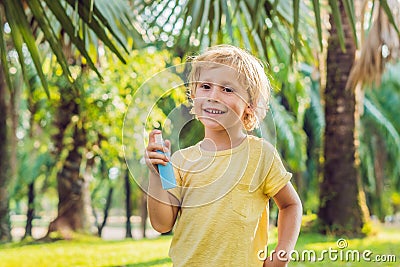 Boy spraying insect repellents on skin Stock Photo