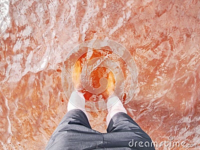 Boy stay in lake with water under knee and test temperature Stock Photo