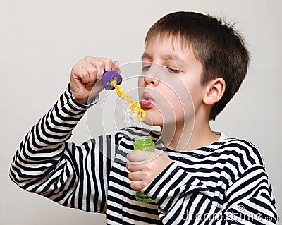 Boy in striped vest and bubbles Stock Photo
