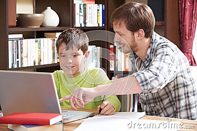 Boy Studying With Home Tutor Stock Photo