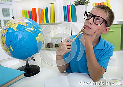 Boy studying about the world,and thinkig something Stock Photo