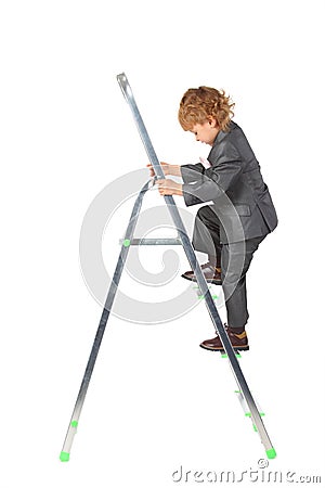 Boy in suit rises on step-ladder Stock Photo