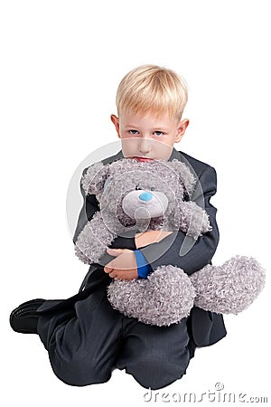 Boy in suit with teddy bear Stock Photo