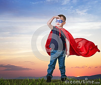 A boy in a Superman costume stands Stock Photo